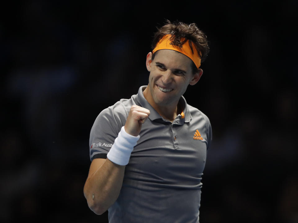 Austria's Dominic Thiem celebrates after defeating Switzerland's Roger Federer in their ATP World Tour Finals singles tennis match at the O2 Arena in London, Sunday, Nov. 10, 2019. (AP Photo/Alastair Grant)