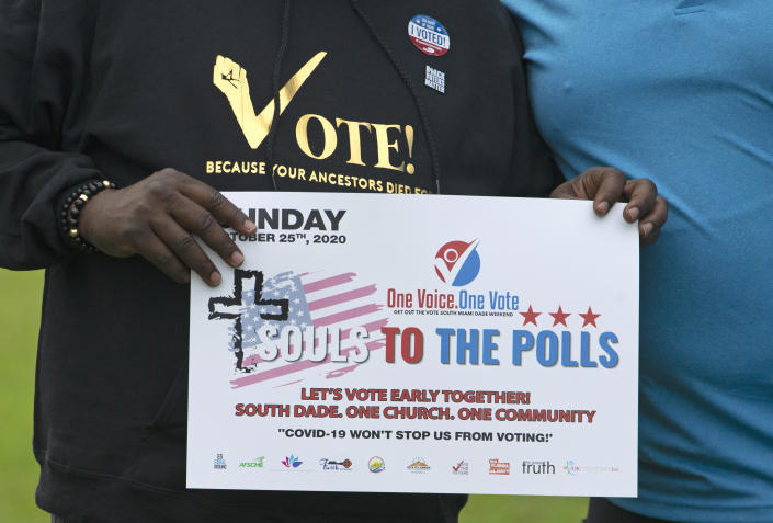 FILE - Souls to the Polls sign before the caravan at The Purple Church as part of one of many events prior to the elections on Sunday, Oct. 25, 2020, in Miami, Fla. Black church leaders in Georgia are organizing rallies to try to get their congregants to vote as part of a longstanding tradition known as “souls to the polls.” The effort is taking on even greater meaning this year after state lawmakers nearly did away with Sunday voting. (David Santiago/Miami Herald via AP)