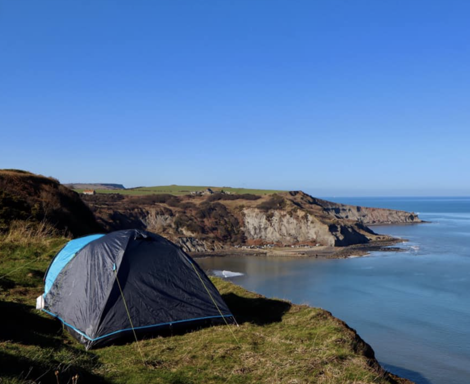 The tent set up just a metre from the cliff's edge in Whitby.