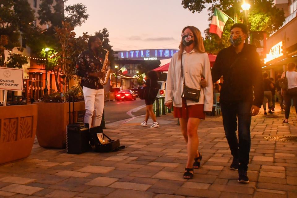The sidewalks are busy along India Street in San Diego's Little Italy neighborhood.