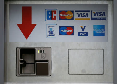 FILE PHOTO: A card slot for various credit and payment cards (Eurocheque, Mastercard, Visa, Visa Electron, girocard Maestro, V-Pay and American Express) is pictured in Duesseldorf, Germany, April 7, 2016. REUTERS/Wolfgang Rattay/File Photo