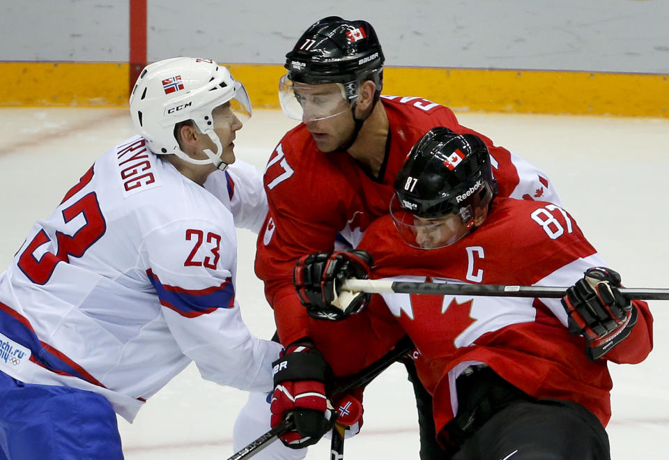 Canada forward Sidney Crosby (87) and forward Jeff Carter collide with Norway defenseman Mats Trygg in the second period of a men's ice hockey game at the 2014 Winter Olympics, Thursday, Feb. 13, 2014, in Sochi, Russia. (AP Photo/Mark Humphrey)