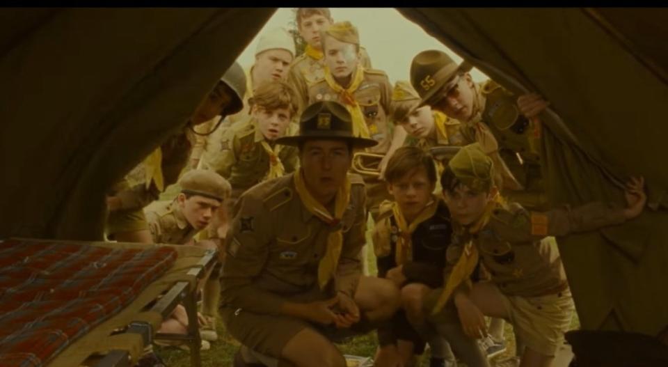 Scout Master Ward and his scouts looking into a tent in "Moonrise Kingdom"