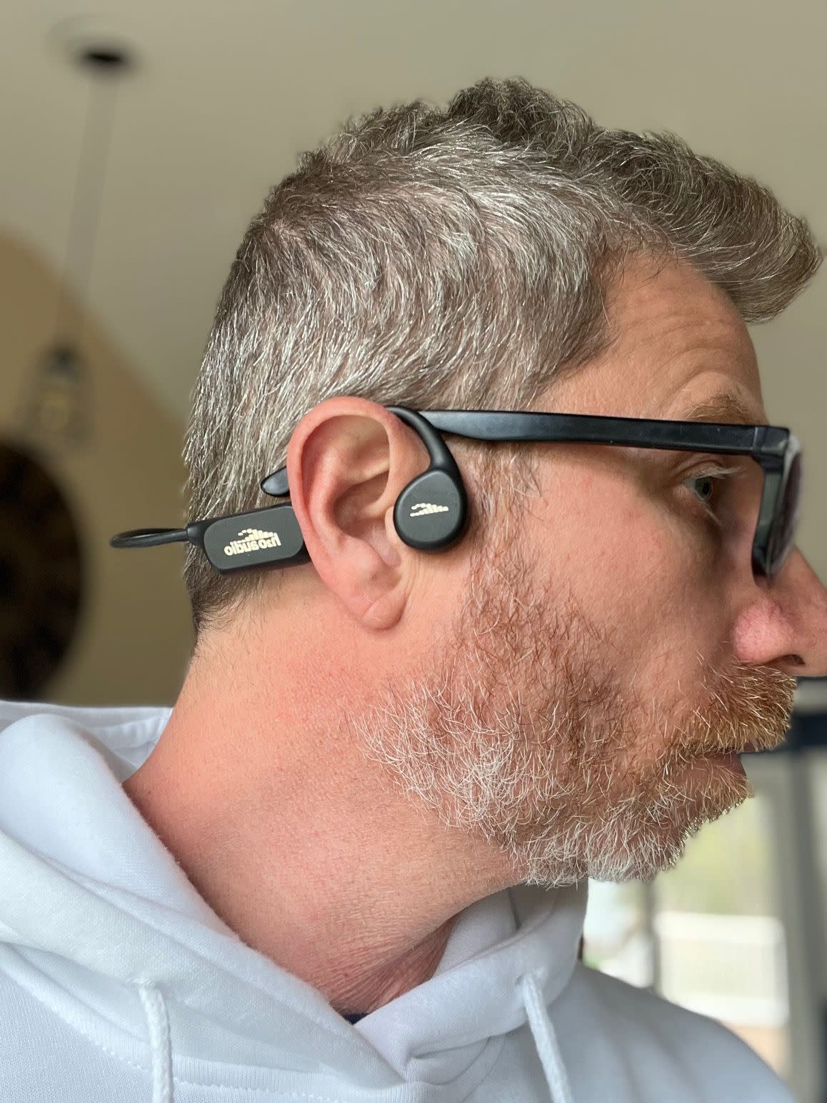 Reviewer wearing the Tri Sport headphones