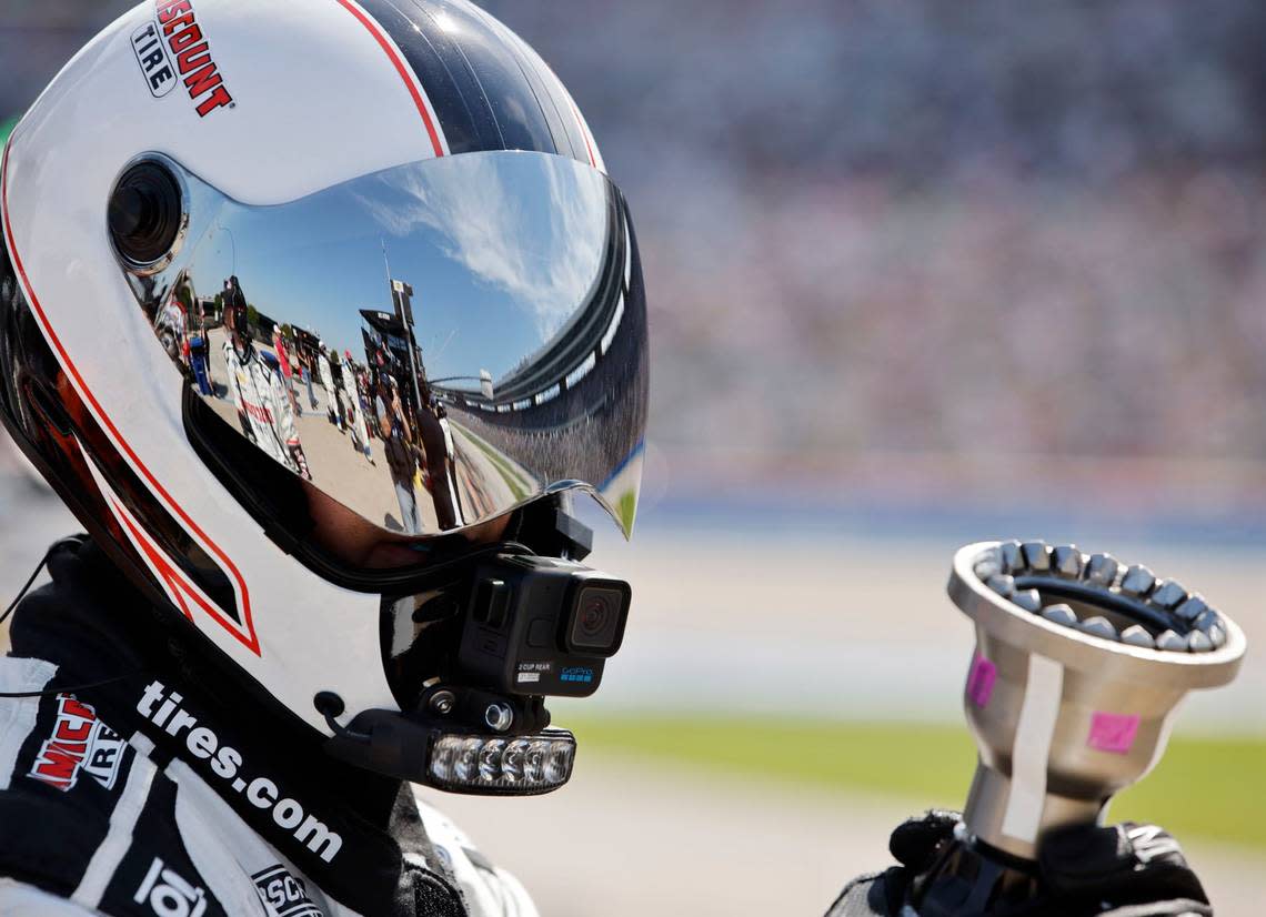 Texas Motor Speedway is reflected off a tire changers face mask during the Auto Trader Echo Park 400 at Texas Motor Speedway in Fort Worth, Texas, April 14, 2024. Kyle Larson won stage 1. (Special to the Star-Telegram/Bob Booth) Bob Booth/(Special to the Star-Telegram)