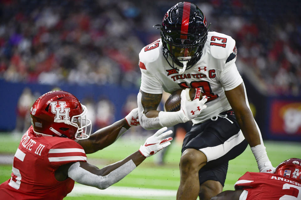 FILE - In this Saturday, Sept. 4, 2021, file photo, Texas Tech wide receiver Erik Ezukanma (13) runs with the ball against Houston during the first half of an NCAA college football game in Houston. There are a few simple explanations about why Texas Tech hasn't really spread the ball around that much on offense. Ezukanma makes things look so easy with all those big plays while leading the nation in receiving and Tahj Brooks has more than 100 yards rushing in both games with four touchdowns when he wasn't even expected to be the team's top running back. Plus, the Red Raiders (2-0) just haven't run a whole lot of plays. (AP Photo/Justin Rex, File)