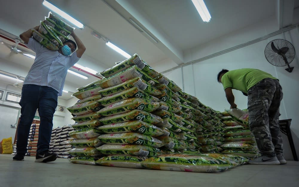 Staff at the Welfare Department in Labuan arrange bags of rice before distributing them to those affected by the Covid-19 pandemic, October 23, 2020. — Bernama pic