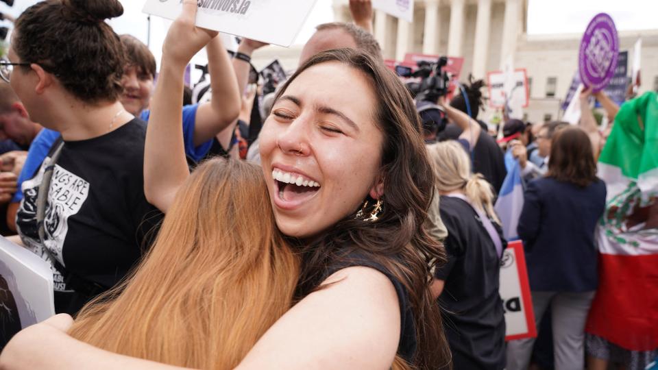 Pro-life supporters hug outside the US Supreme Court in Washington, DC, on June 24, 2022. - The US Supreme Court on Friday ended the right to abortion in a seismic ruling that shreds half a century of constitutional protections on one of the most divisive and bitterly fought issues in American political life. The conservative-dominated court overturned the landmark 1973 