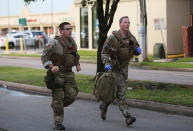 <p>Law enforcement officers run toward the scene of a shooting along Wesleyan at Law Street in Houston that left multiple people injured and the alleged shooter dead, Sunday morning, Sept. 25, 2016. (Mark Mulligan/Houston Chronicle via AP) </p>