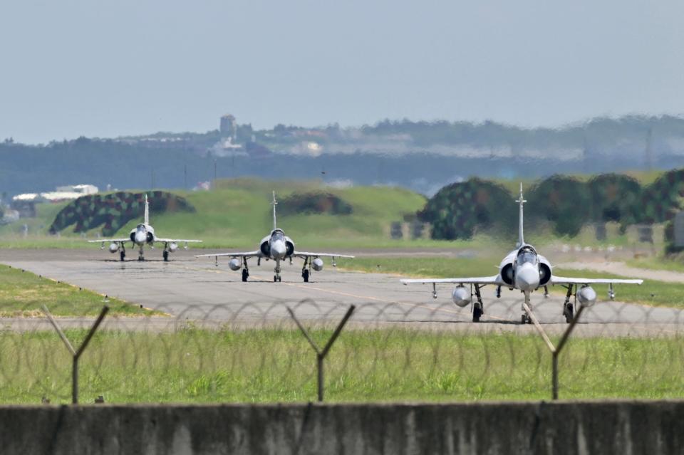 Three French-made Mirage 2000 fighter jets taxi on a runway in front of a hangar at the Hsinchu Air Base in Hsinchu on 5 August 2022 (AFP via Getty Images)