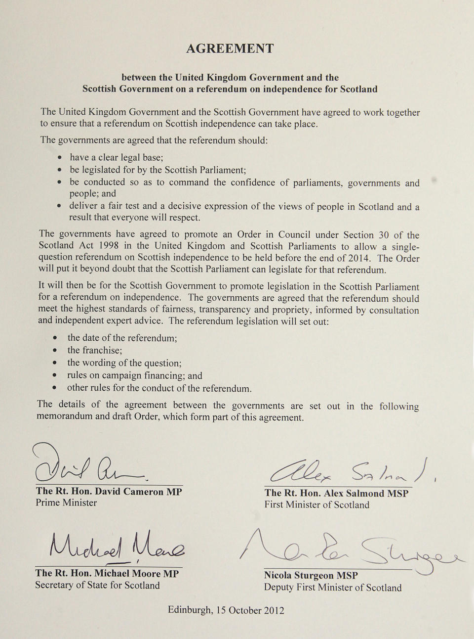 The referendum agreement signed by Prime Minister David Cameron, Scotland First Minister Alex Salmond, Scottish Secretary Michael Moore and Deputy First Minister Nicola Sturgeon during a meeting at St Andrews House in Edinburgh, Monday, Oct. 15, 2012. Cameron met with the leader of Scotland's separatist administration Monday to sign a deal on a referendum that could break up the United Kingdom. Officials from London and Edinburgh have been meeting for weeks to hammer out details of a vote on Scottish independence. Sticking points included the date and the wording of the question. (AP Photo/Gordon Terris, Pool)