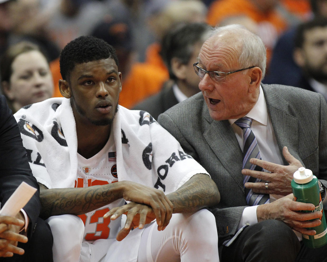 Syracuse head coach Jim Boeheim, right, talks with Syracuse's Frank Howard, left, on the bench during the second half of an NCAA college basketball game against Louisville in Syracuse, N.Y., Wednesday, Feb. 20, 2019. Syracuse won 69-49. (AP Photo/Nick Lisi)