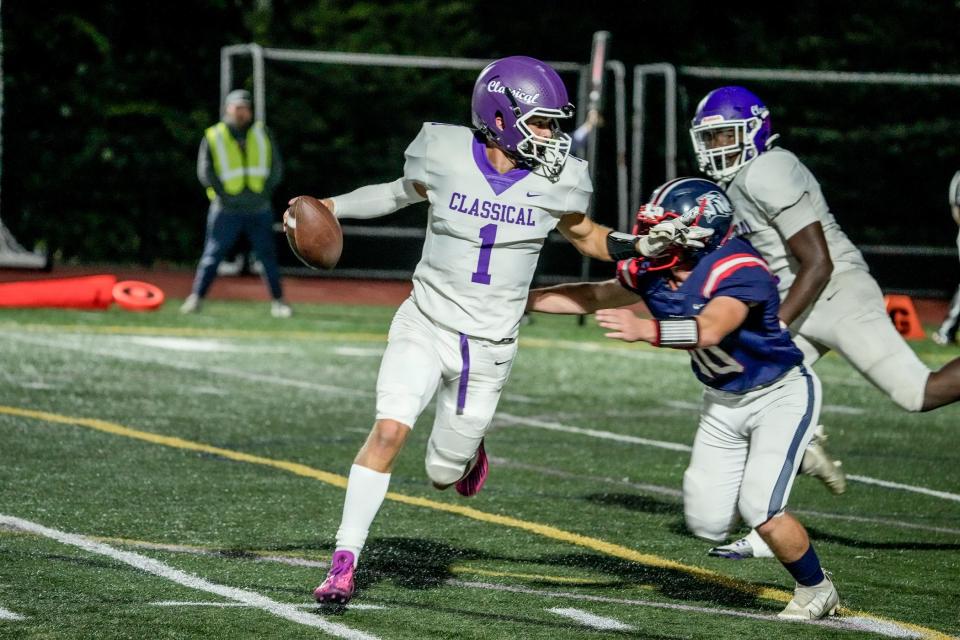 Classical's Tyler Lee is chased out of the pocket by Lincoln's John Nicoll during Friday night's game.