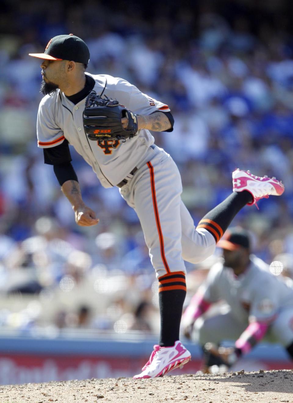 San Francisco Giants relief pitcher Sergio Romo throws against the Los Angeles Dodgers in the ninth inning of a baseball game on Sunday, May 11, 2014, in Los Angeles. (AP Photo/Alex Gallardo)