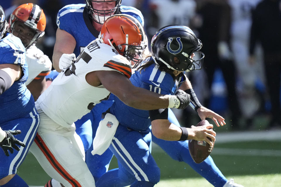 Indianapolis Colts quarterback Gardner Minshew (10) is sacked by Cleveland Browns defensive end Myles Garrett (95) during the first half of an NFL football game, Sunday, Oct. 22, 2023, in Indianapolis. (AP Photo/AJ Mast)