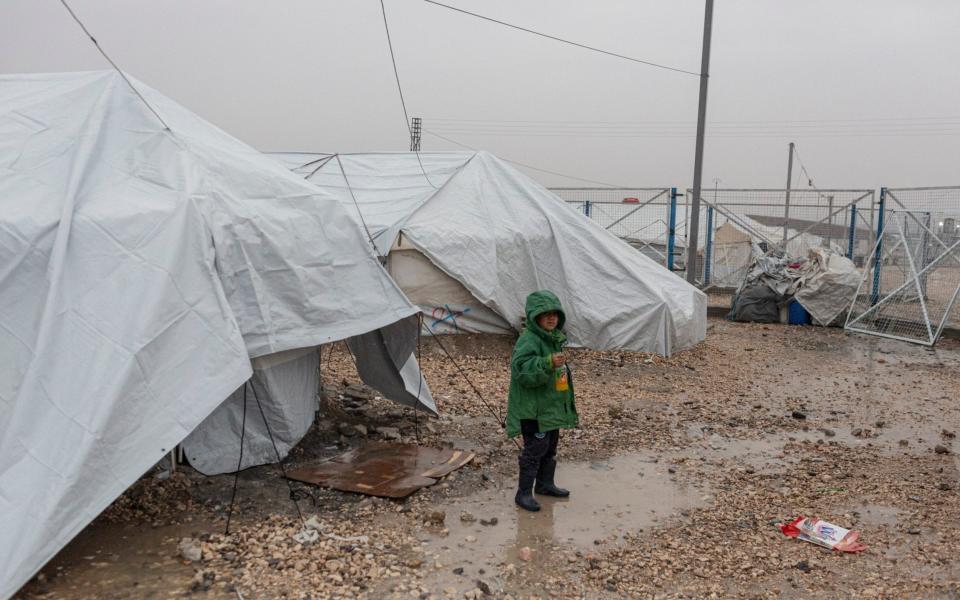 A young British child, who was born in Raqqa, stands outside the tent in which he and his mother live - Sam Tarling for The Telegraph