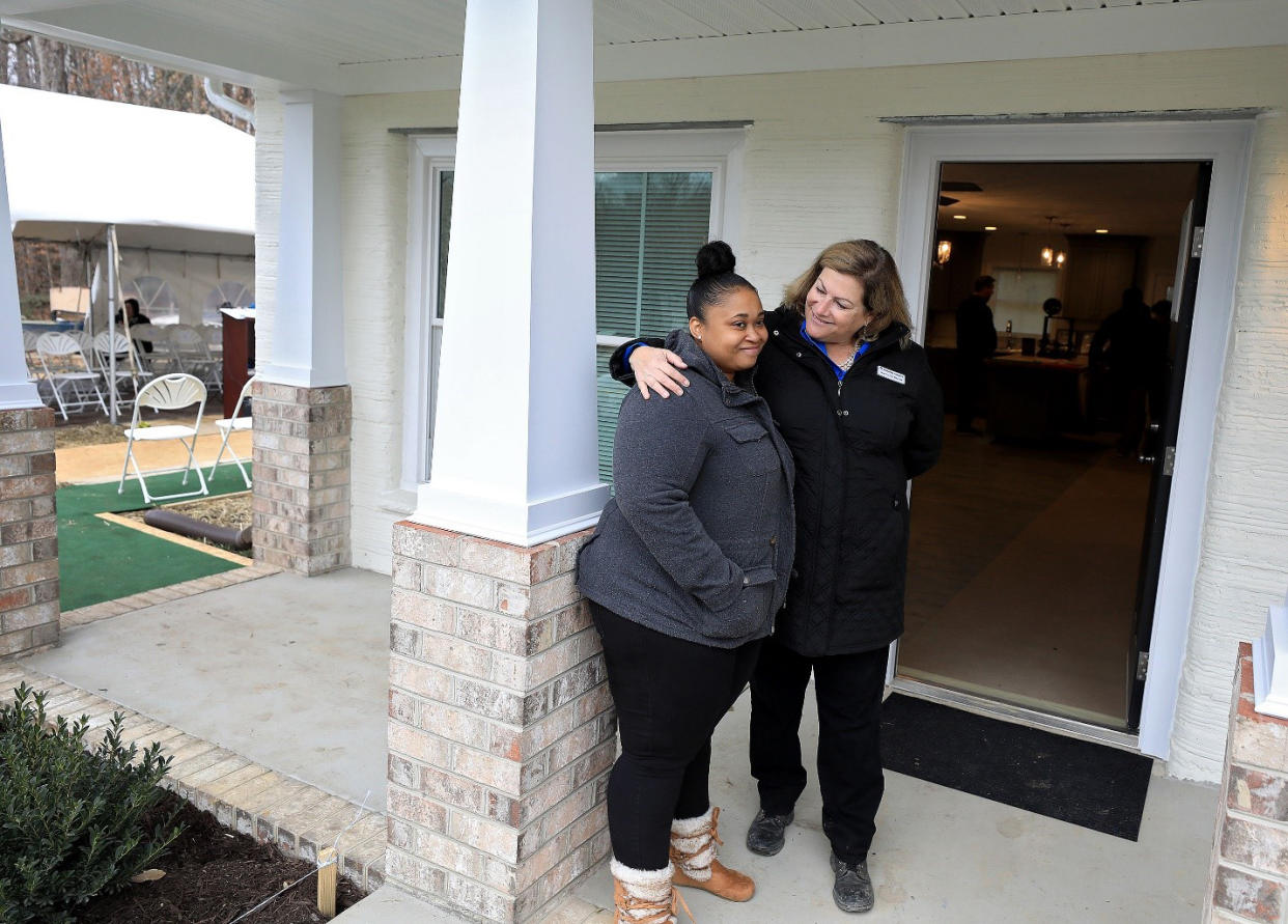 April volunteers during installation of 3D-printed house walls at a Habitat for Humanity site. (Consociate Media)