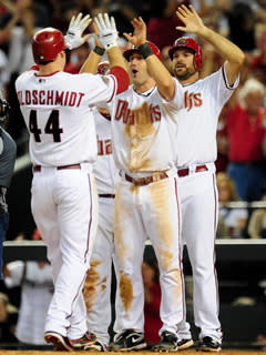 Paul Goldschmidt rounded the bases after his grand slam and was met by Willie Bloomquist (center) and pitcher Josh Collmenter