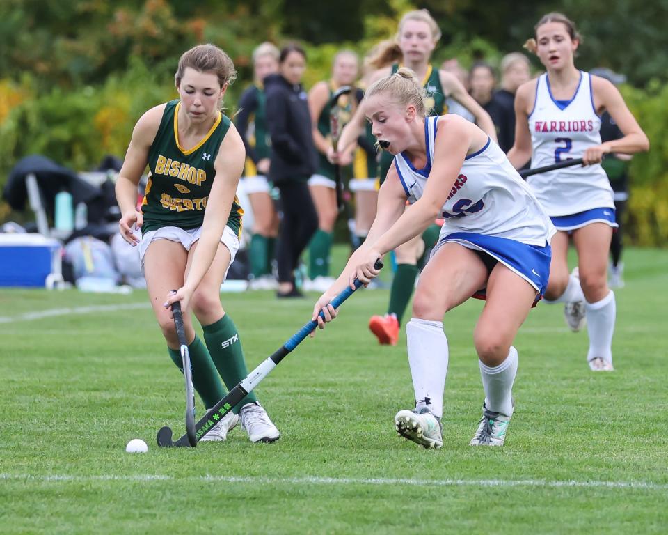 Winnacunnet's Jen Frost, right, battles with Bishop Guertin's Jazmine Shattuck for control of the ball during a game last season.