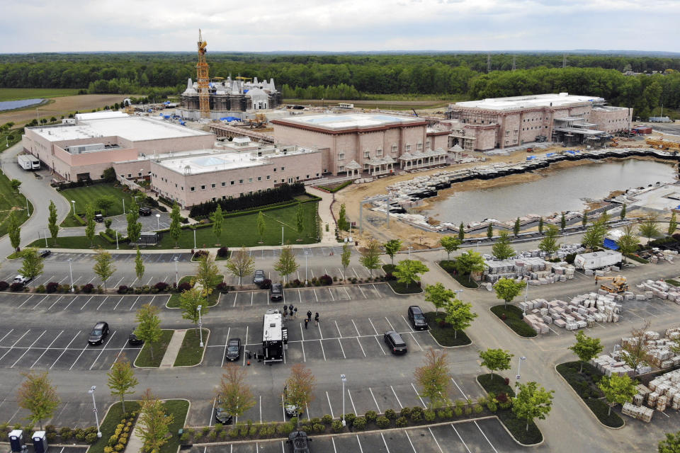 FILE - A view of the BAPS Shri Swaminarayan Mandir is seen in Robbinsville Township, N.J., Tuesday, May 11, 2021. A lawsuit in which workers accuse a Hindu organization of human trafficking by luring them from India to build the temple in New Jersey for as little as $1.20 a day has widened to four other states. In the initial lawsuit filed in May, workers at the Hindu temple in Robbinsville, claimed leaders of the Hindu organization known as Bochasanwasi Akshar Purushottam Swaminarayan Sanstha, or BAPS, coerced them into signing employment agreements and forced them to work more than 12 hours per day with few days off, under the watch of security guards. (AP Photo/Ted Shaffrey, File)