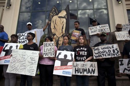 Protesters carry signs at a rally in North Charleston, South Carolina in this April 8, 2015 file photo. REUTERS/Randall Hill/Files