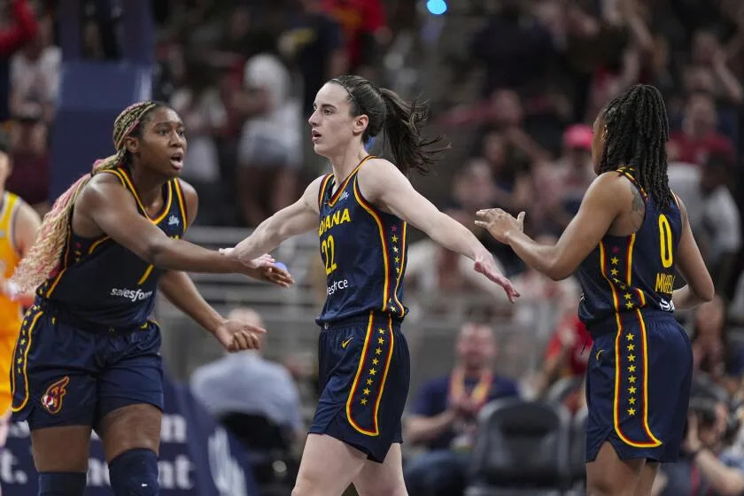 Indiana Fever guard Caitlin Clark (22) is congratulated by Aliyah Boston (7) and Kelsey Mitchell (0)