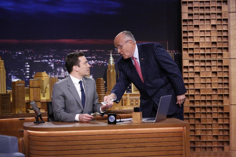 In this photo provided by NBC, Jimmy Fallon appears with former New York City Mayor Rudy Giuliani, right, during his "The Tonight Show" debut on Monday, Feb. 17, 2014, in New York. Fallon departed from the network's “Late Night” on Feb. 7, 2014, after five years as host, and is now the host of “The Tonight Show,” replacing Jay Leno after 22 years. (AP Photo/NBC, Lloyd Bishop)