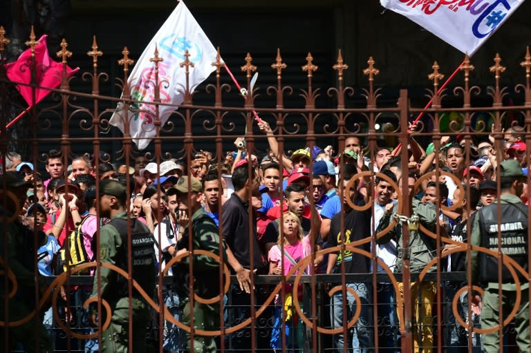 Government opponents gather outside the National Assembly in Caracas as Venezuela's opposition ratchets up the pressure on President Nicolas Maduro