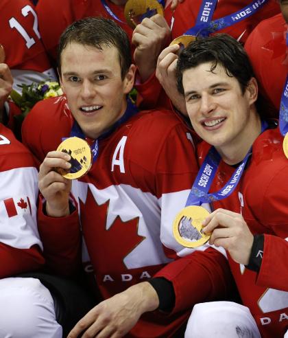 Canada forwards Jonathan Towes, left, and Sidney Crosby, right, pose with their medals after beating Sweden 3-0 in the men&#39;s ice hockey gold medal game at the 2014 Winter Olympics, Sunday, Feb. 23, 2014, in Sochi, Russia. (AP Photo/Mark Humphrey)