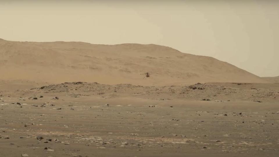 The Ingenuity helicopter flying around Mars