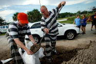 <p>Inmate trustees from the Brevard County Jail work to fill and load sandbags for residents as people in the area prepare ahead of Hurricane Irma on Sept. 7, 2017 in Meritt Island, Fla. (Photo: Brian Blanco/Getty Images) </p>
