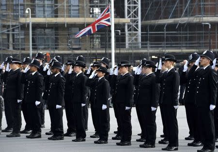 A Union flag is flown at half mast as police recruits stand during their passing out parade, following a recent attack in Westminster, London, Britain March 24, 2017. REUTERS/Nick Ansell/Pool