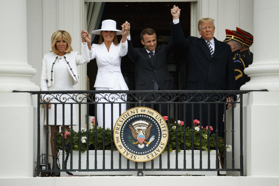 France’s first lady, Brigitte Macron; first lady Melania Trump, French President Emmanuel Macron and President Trump join hands at a ceremony on the South Lawn of the White House on April 24, 2018. (Photo: Evan Vucci/AP)