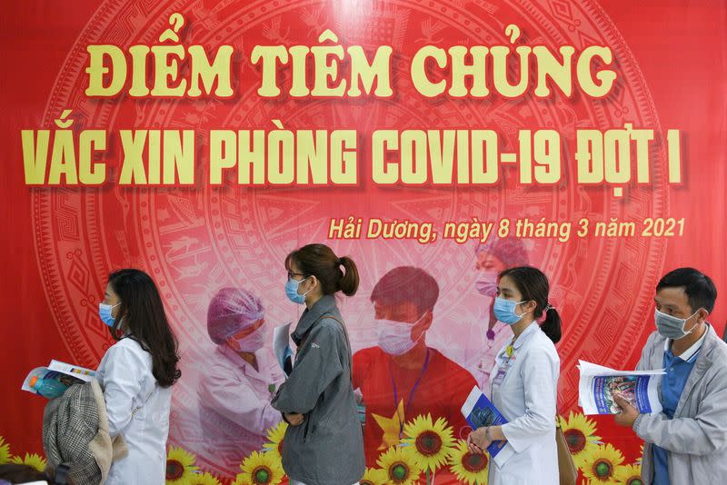 FILE PHOTO: Health workers wait for their turn as Vietnam starts its official rollout of AstraZeneca's COVID-19 vaccine, in Hai Duong