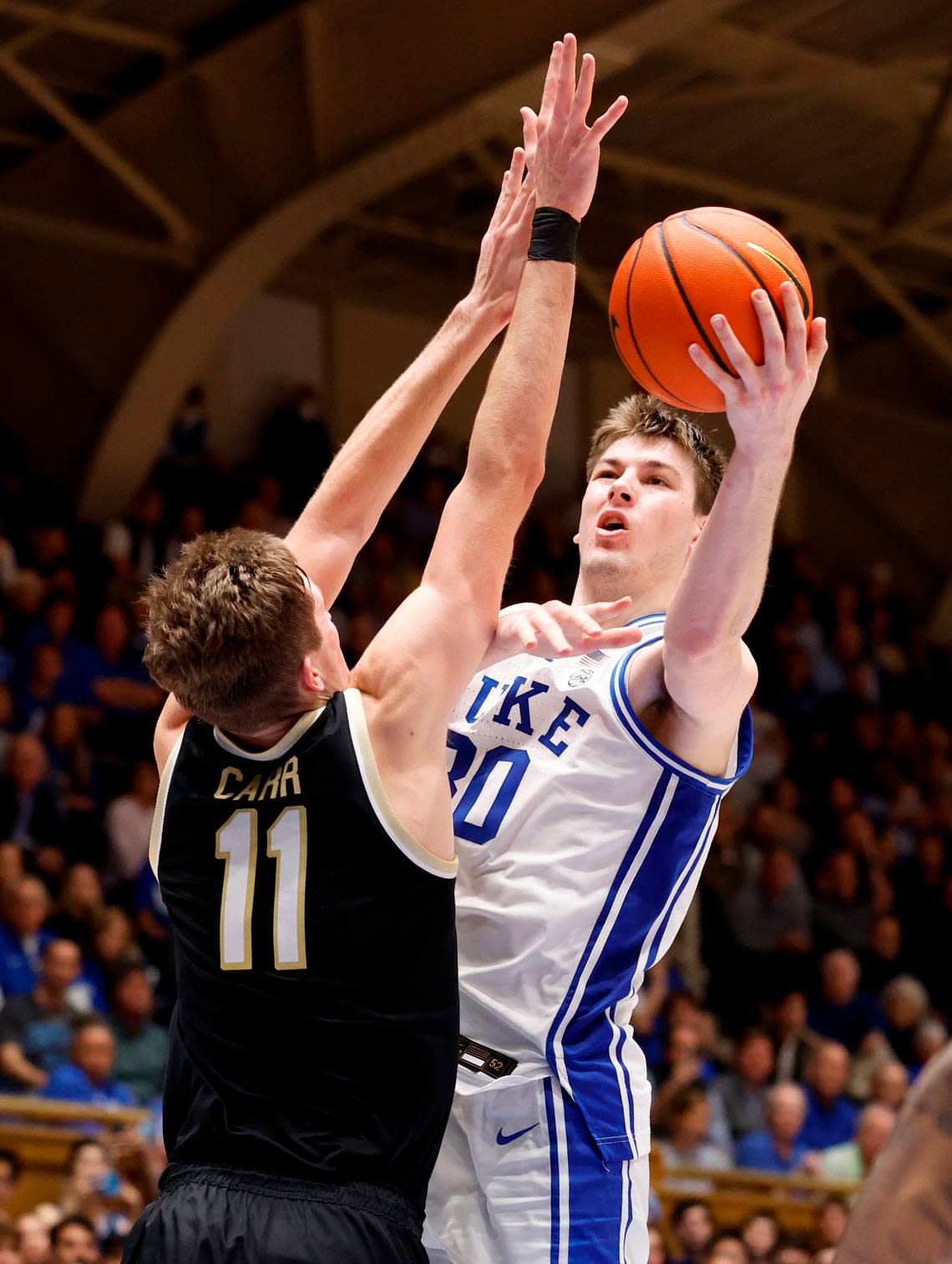 Duke’s Kyle Filipowski (30) drives to the basket past Wake Forest’s Andrew Carr (11) during the second half of Duke’s 75-73 victory over Wake Forest at Cameron Indoor Stadium in Durham, N.C., Tuesday, Jan. 31, 2023.