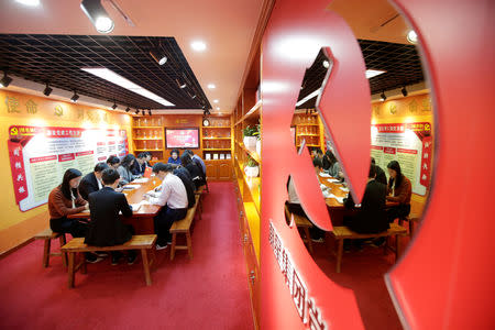 Party members, employees of at Tidal Star Group, attend a weekly group study at their party activity room in Beijing, China, February 25, 2019. Picture taken February 25, 2019. REUTERS/Jason Lee