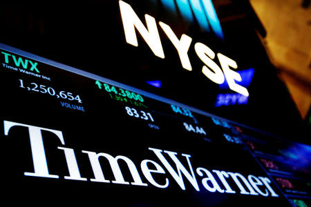 Ticker and trading information for media conglomerate Time Warner Inc. is displayed at the post where it is traded on the floor of the New York Stock Exchange (NYSE) in New York City, U.S., October 21, 2016. REUTERS/Brendan McDermid/File Photo
