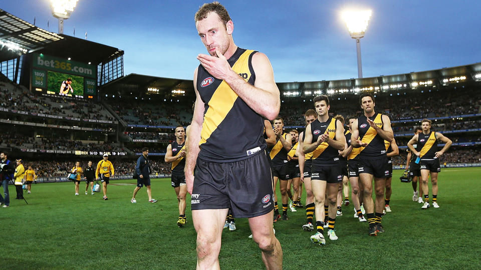 Shane Tuck is pictured being clapped off the field by his teammates in 2013.