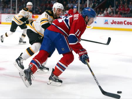 May 12, 2014; Montreal, Quebec, CAN; Montreal Canadiens right wing Brendan Gallagher (11) plays the puck against Boston Bruins center Gregory Campbell (11) during the third period in the game six of the second round of the 2014 Stanley Cup Playoffs at Bell Centre. Mandatory Credit: Jean-Yves Ahern-USA TODAY Sports