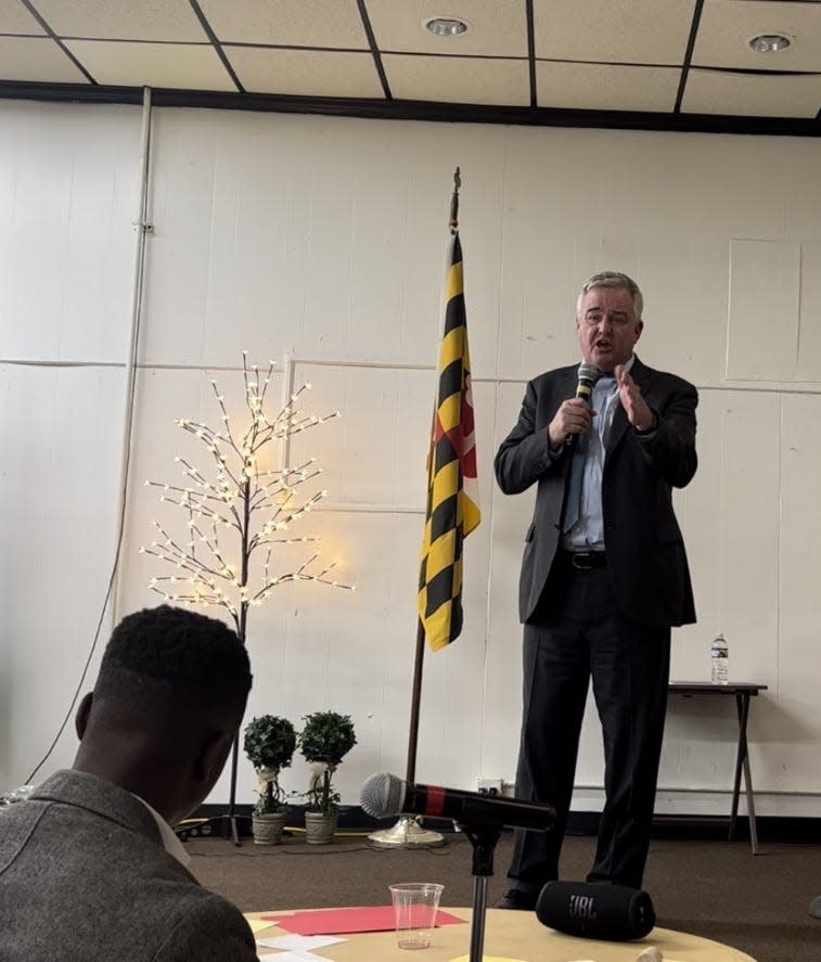 Congressman David Trone, a U.S. Senate candidate, speaks on stage during a forum held by Eastern Shore Democrats in Cambridge, Maryland on Nov. 3, 2023 as moderator Sam Shoge looks on from below. Trone received the second most votes in a three candidate straw poll.