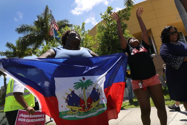 Francesca Menes, left, and others protest in front of the U.S. Citizenship and Immigration Services office in Broward County, Florida, on May 21, 2017, to urge the Department of Homeland Security to extend Temporary Protected Status for Haitian immigrants. (Photo: Joe Raedle via Getty Images)