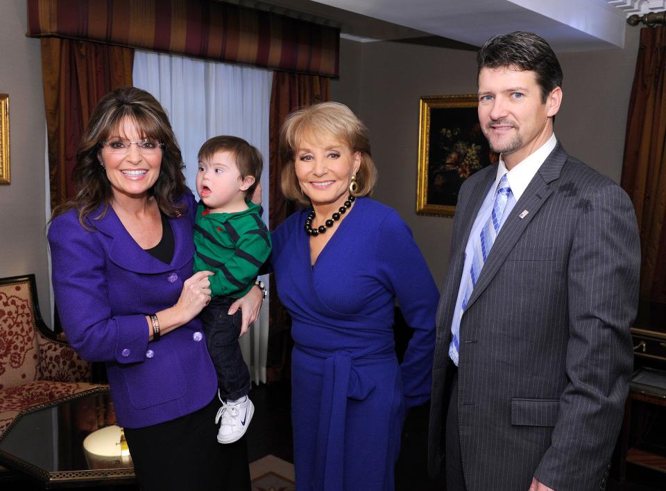 From left: Sarah Palin holds her son Trig during an interview with Barbara Walters and Todd Palin in November 2009.