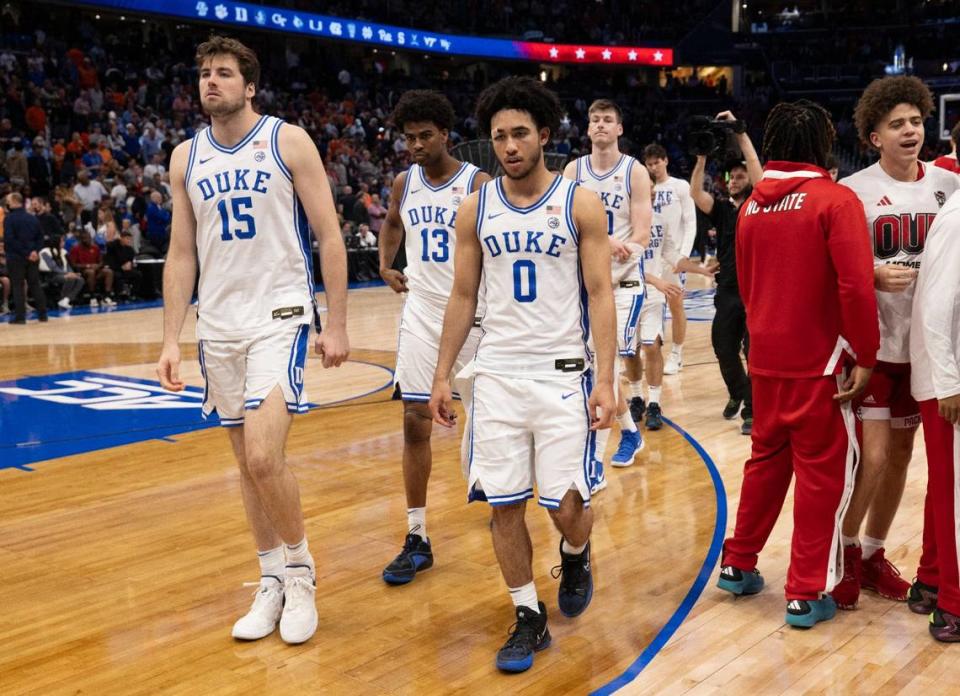 Duke’s Ryan Young (15), Sean Stewart (13) and Jared McCain (0) leave the court following their 79-64 loss to N.C. State in the quarterfinals of the ACC Men’s Basketball Tournament at Capitol One Arena on Wednesday, March 13, 2024 in Washington, D.C. Robert Willett/rwillett@newsobserver.com