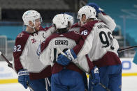 Colorado Avalanche right wing Mikko Rantanen, right, is congratulated by teammates after scoring a goal against the San Jose Sharks during the second period of an NHL hockey game in San Jose, Calif., Wednesday, March 3, 2021. (AP Photo/Jeff Chiu)