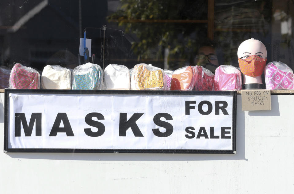 Face masks on sale at Muizenberg, Cape Town, South Africa, Tuesday June 16, 2020. The country now has more than a quarter of the coronavirus cases on the 54-nation African continent with more than 73,000 cases after new, record-high infections were registered in South Africa over the weekend. (AP Photo/Nardus Engelbrecht)