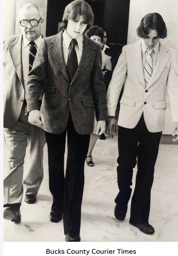 Robert Buli, left, and John Lekka, are handcuffed together as they are walked through the Bucks County Courthouse at their 1979 murder trial for the bludgeoning death of Diane Goeke, 17, of Levittown.