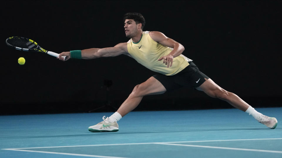 Carlos Alcaraz of Spain plays a forehand return to Miomir Kecmanovic of Serbia during their fourth round match at the Australian Open tennis championships at Melbourne Park, Melbourne, Australia, Monday, Jan. 22, 2024. (AP Photo/Andy Wong)