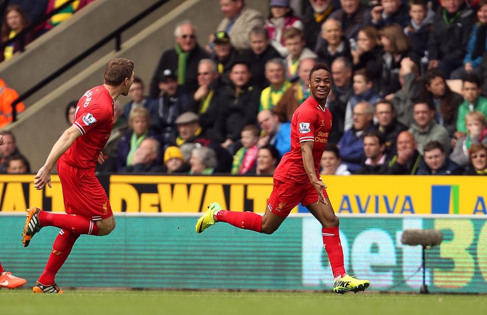 Liverpool's Raheem Sterling, right, celebrates scoring the opening goal during their English Premier League match against Norwich City at Carrow Road, Norwich, eastern England, Sunday April 20, 2014. (AP Photo/PA, Chris Radburn) UNITED KINGDOM OUT NO SALES NO ARCHIVE