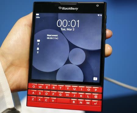 A man displays the new Blackberry Passport smartphone during the Mobile World Congress in Barcelona March 3, 2015. REUTERS/Gustau Nacarino