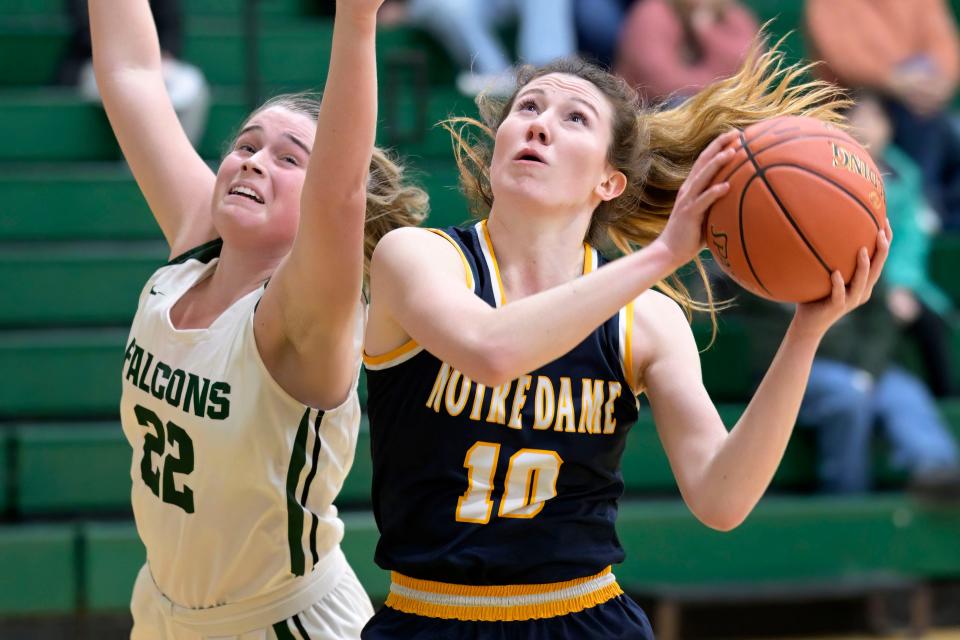 Notre Dame's Gabby Deery (10) drive to the basket against West Burlington's Isabella Callison Tuesday at West Burlington.